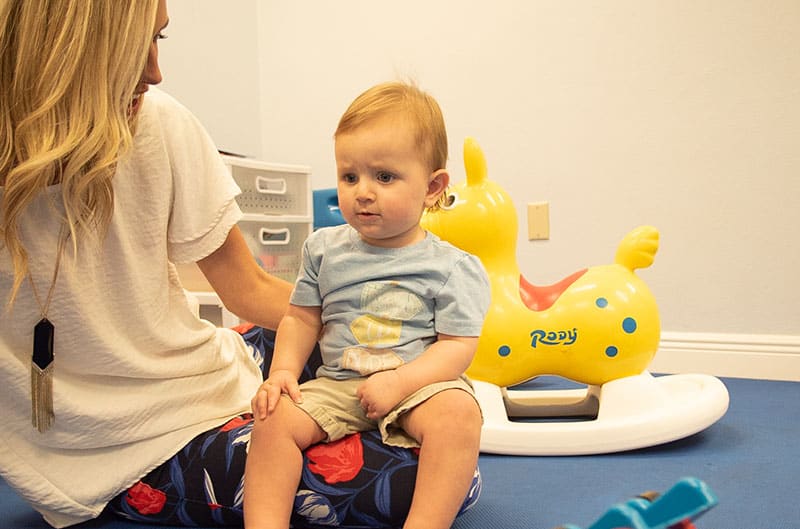 pediatric-physical-therapy-test_800x529 baby sitting on pediatric therapist's lap